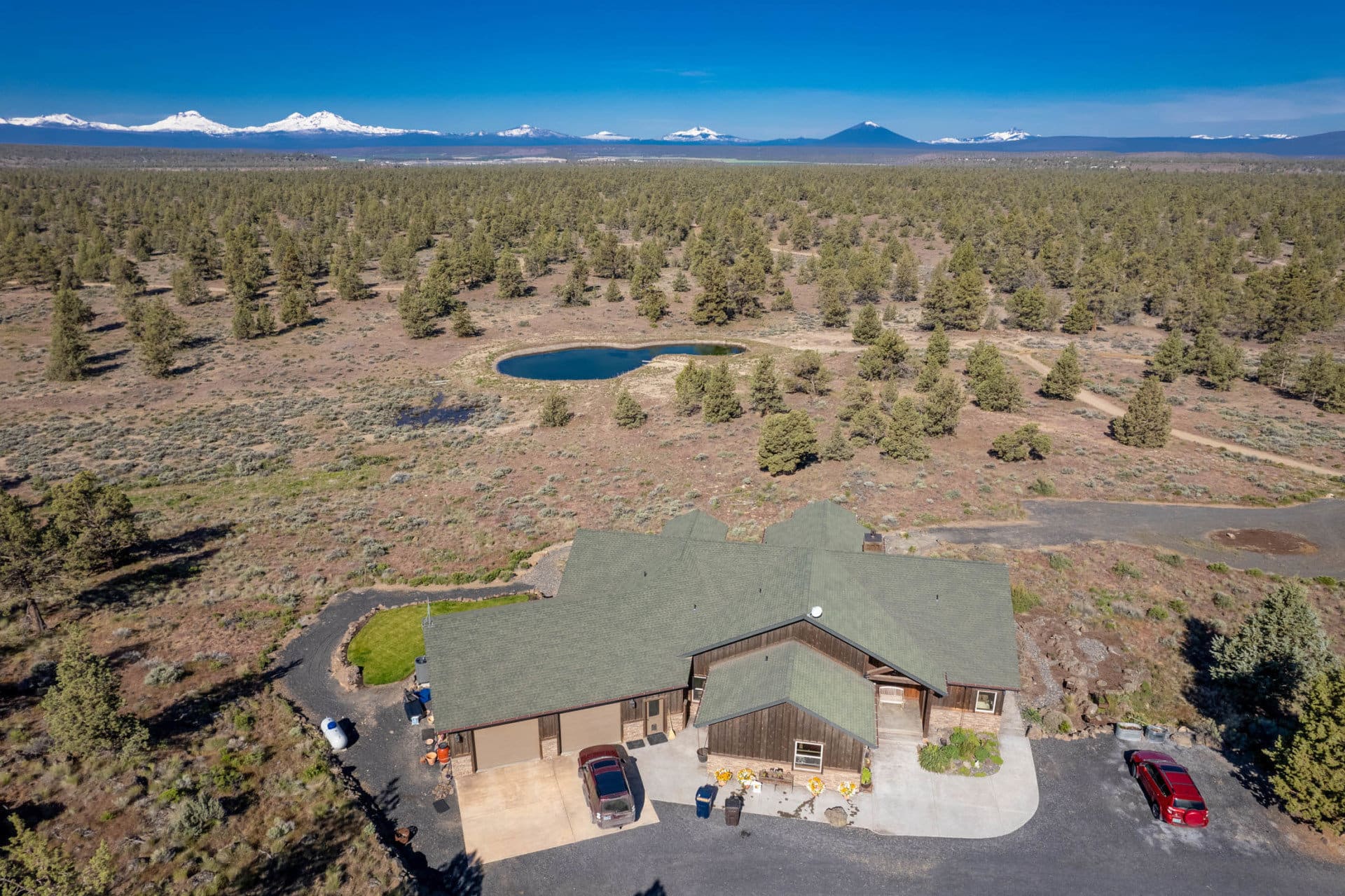 aerial residence with pond and mountains oregon terrebonne equestrian estate