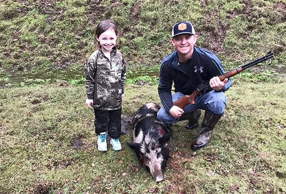 Justin davis real estate and shyla with little wild pig