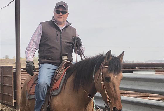 Oscar Evans Idaho broker horseback