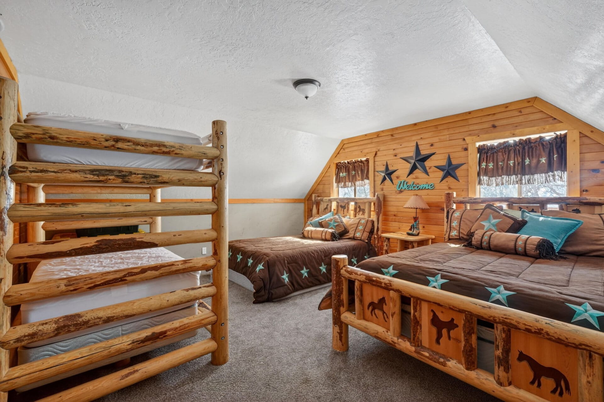 cabin bedroom with multiple Idaho log beds the davis lodge at loafer creek falls