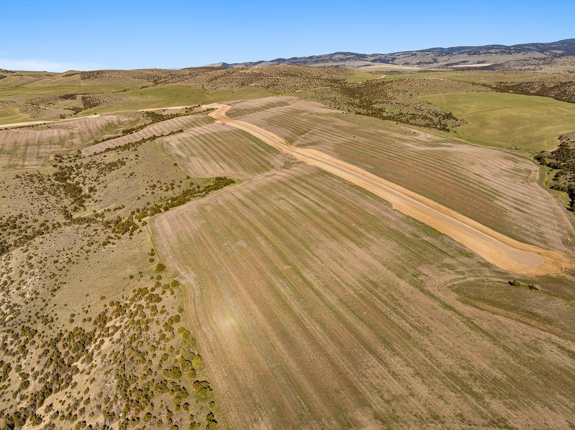 aerial view cultivated fields with winding road land montana golden meadow at sxs ranch