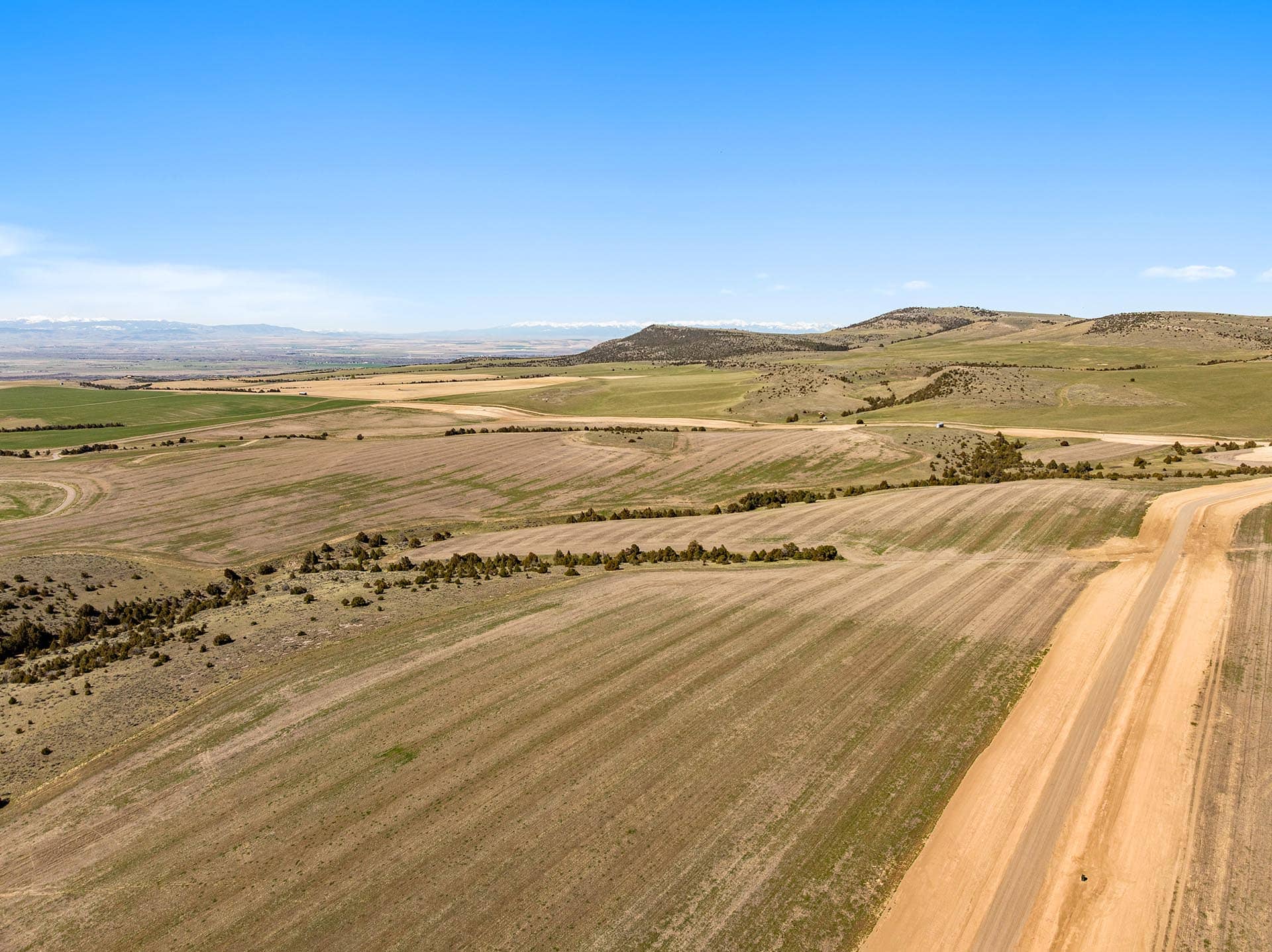 agricultureal land for sale with tilled fields and distant mountains montana skinner road sanctuary at sxs ranch