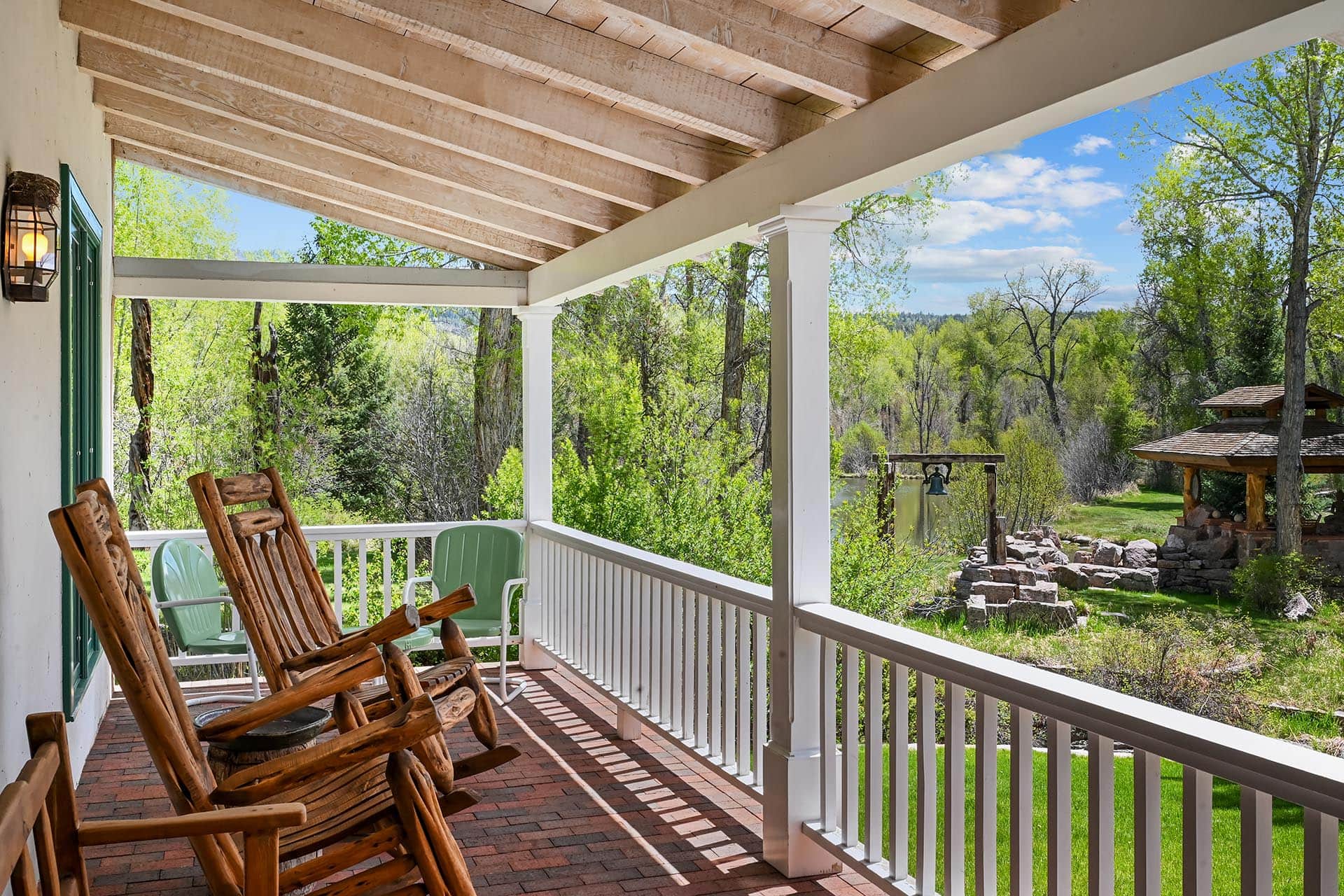 covered porch with rocking chairs and water view residential estate new mexico old canones creek ranch