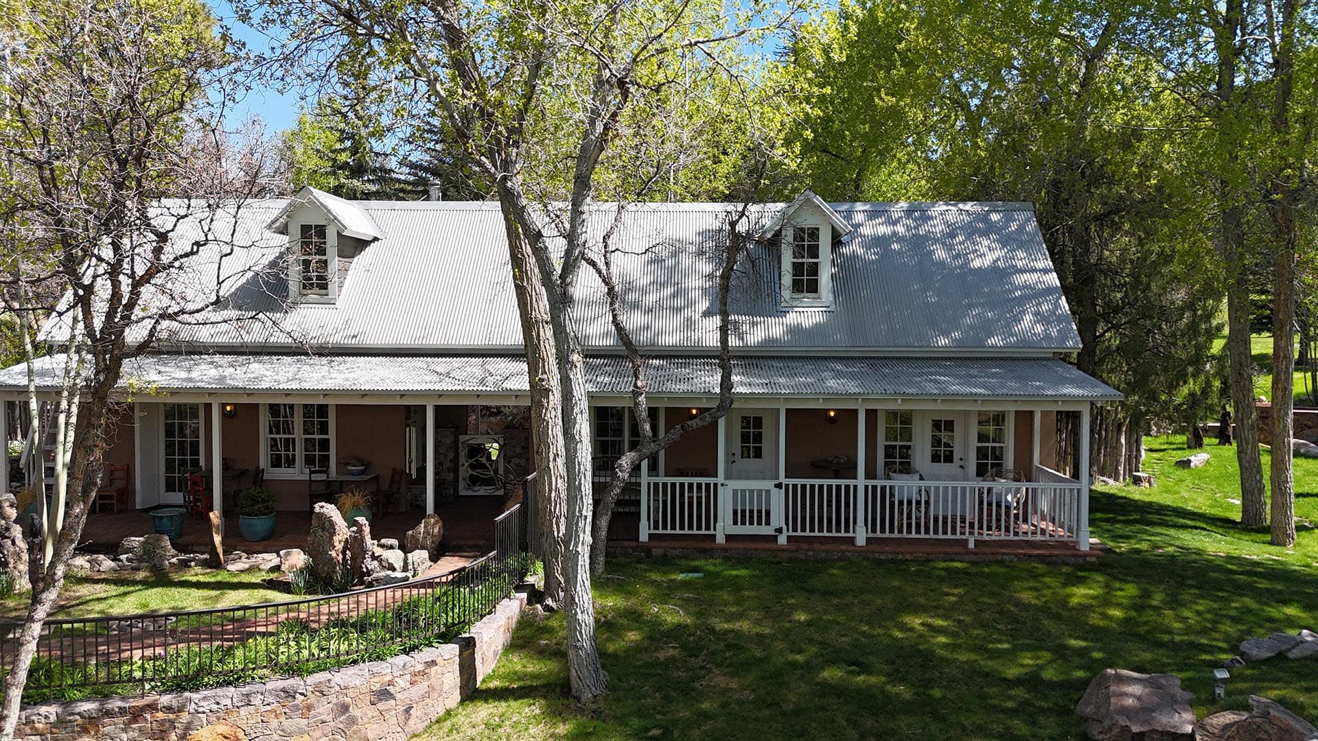 house exterior with metal roof and covered porch residential estate for sale new mexico old canones creek ranch