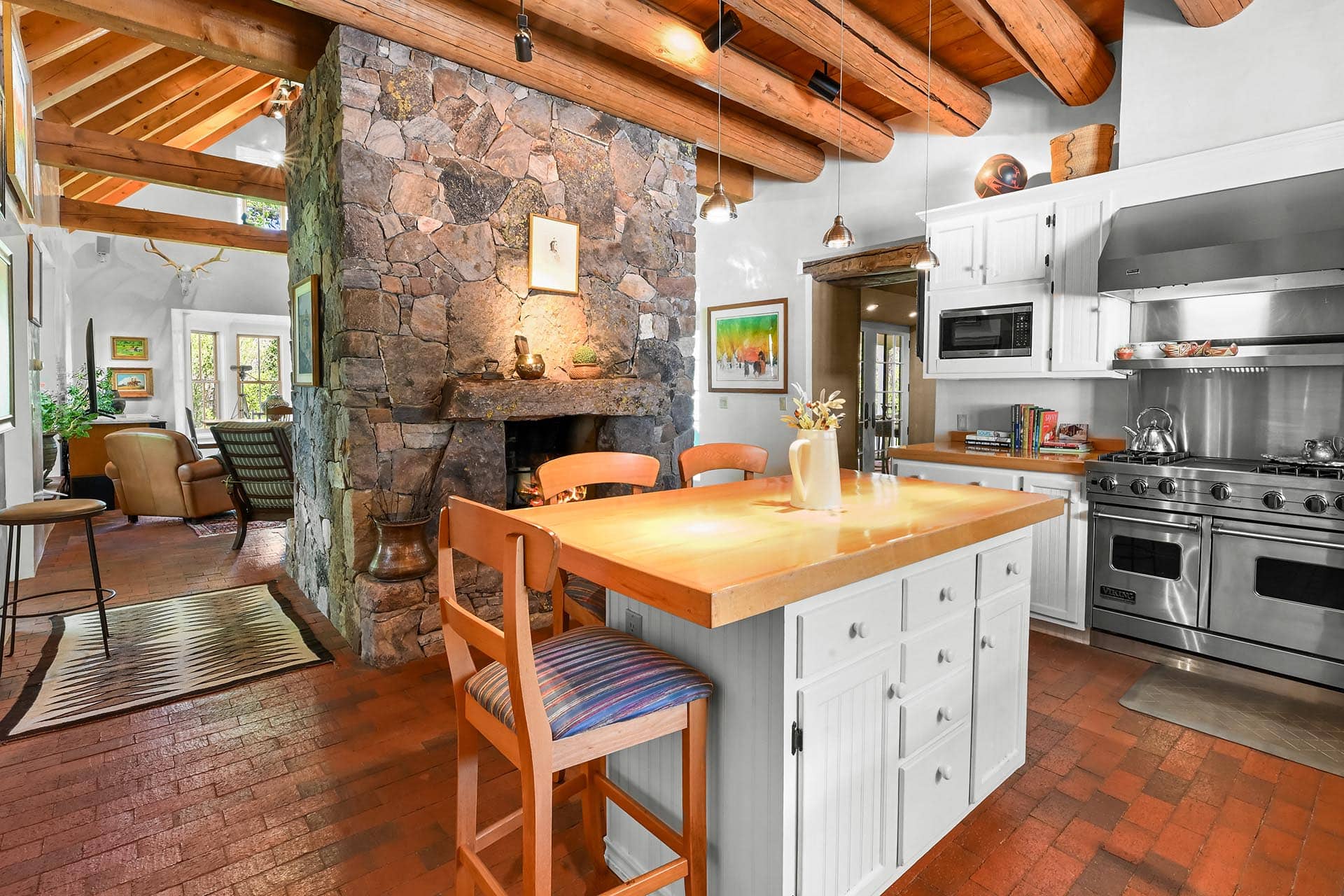 kitchen with butcher block island and stone fireplace residential estate property for sale new mexico old canones creek ranch