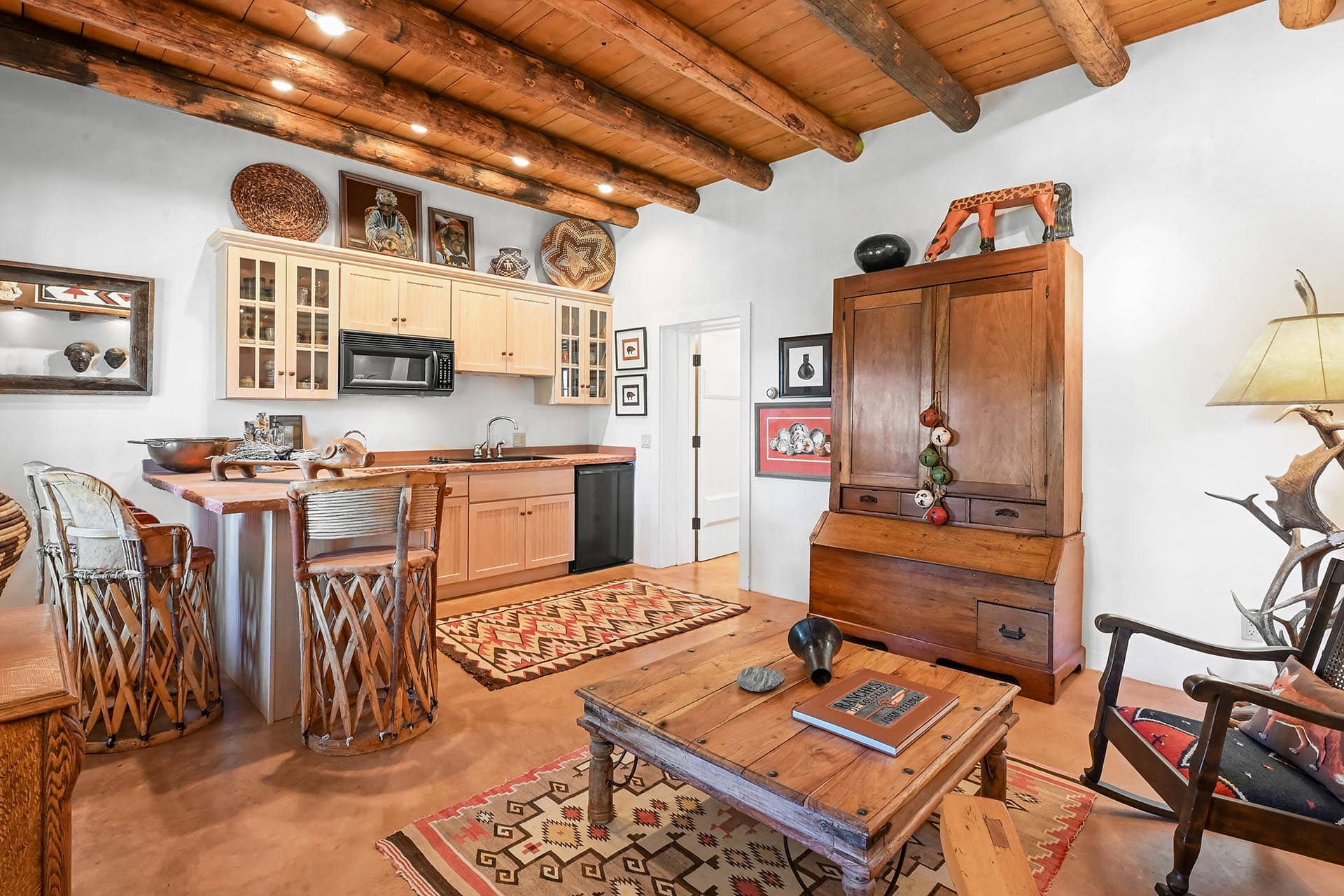kitchen with wooden bar and vigas ceiling residential estate property for sale new mexico old canones creek ranch