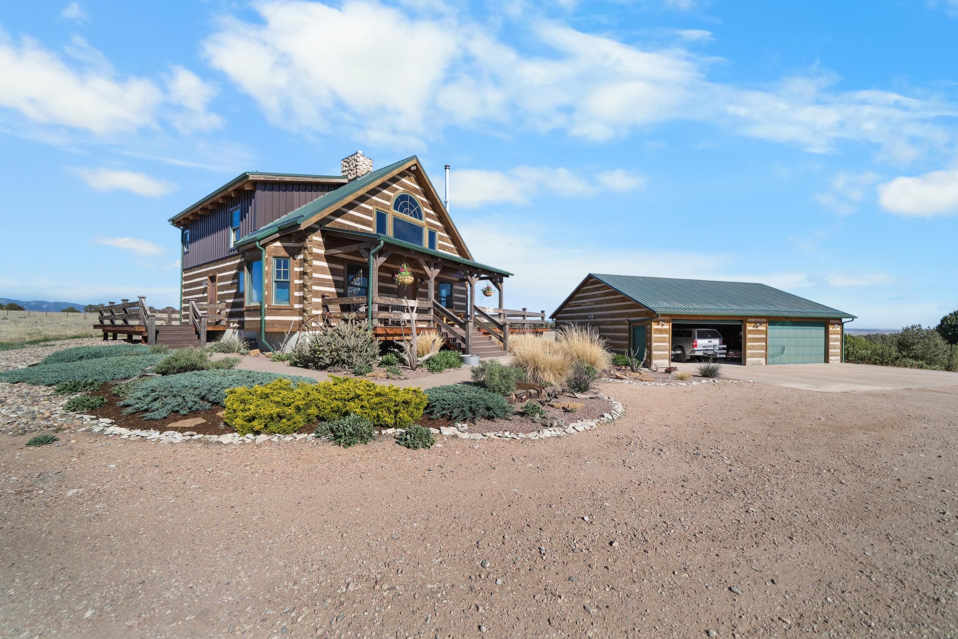 log home with landscaped entrance colorado mchenry ranch