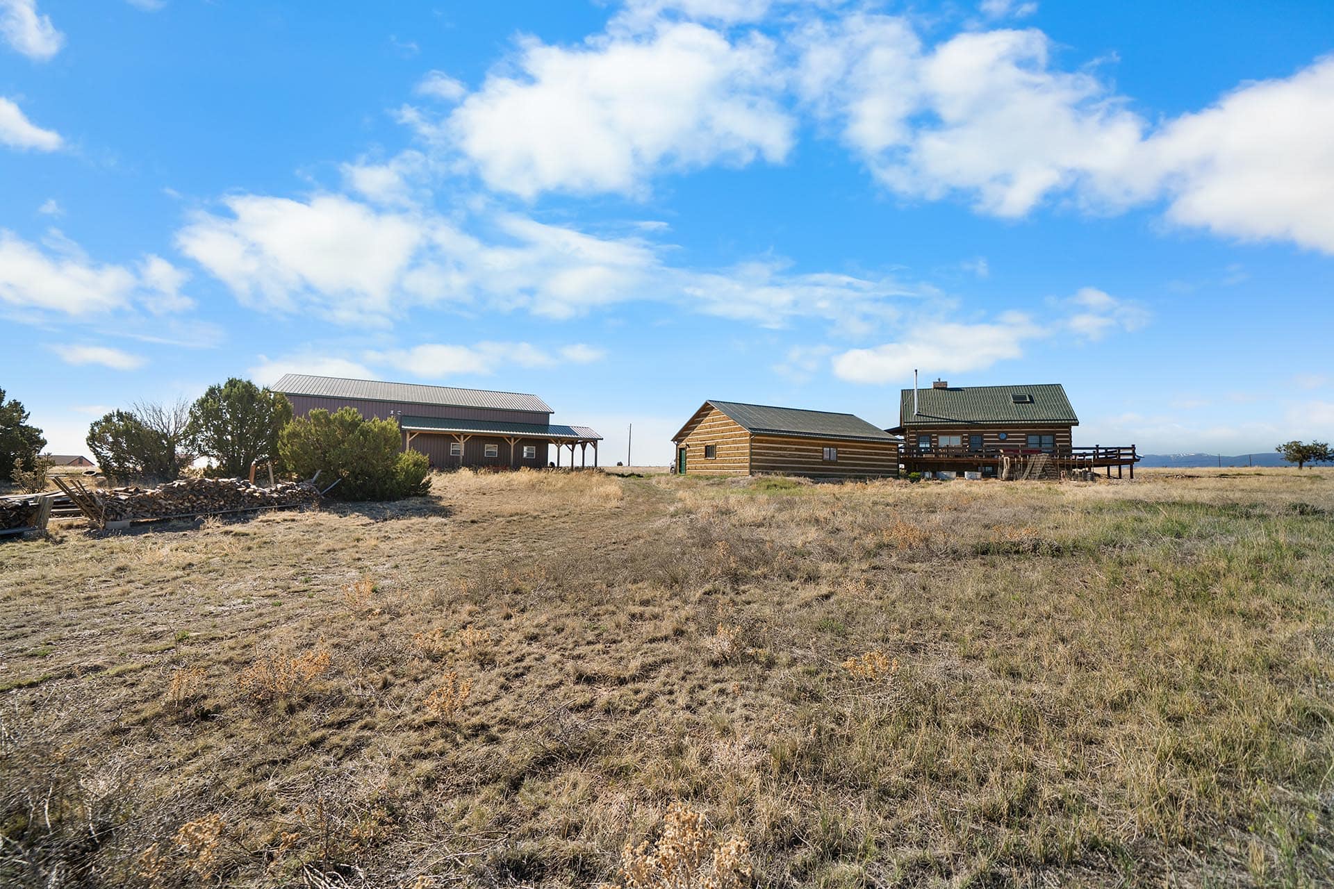 log home with large deck and outbuildings colorado mchenry ranch