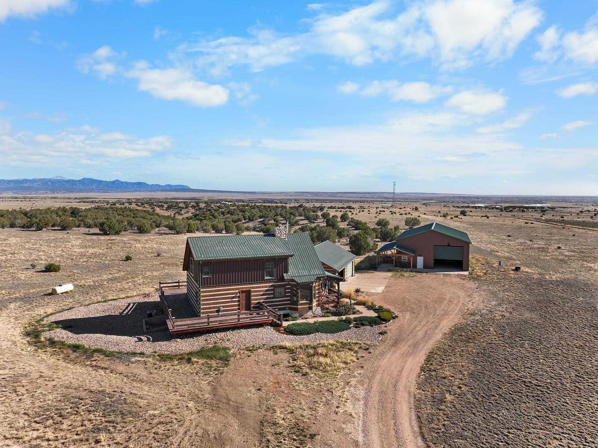 log home with shop building aerial view colorado mchenry ranch