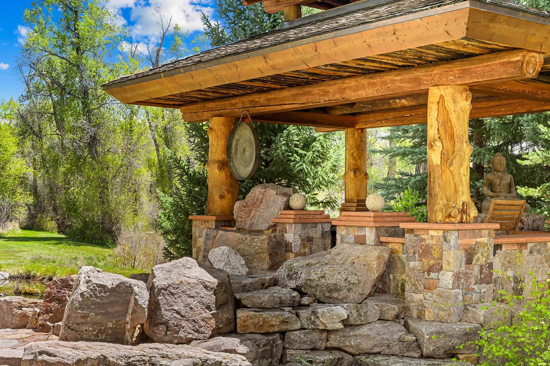 stone and wood pavilion with gong residential estate new mexico old canones creek ranch