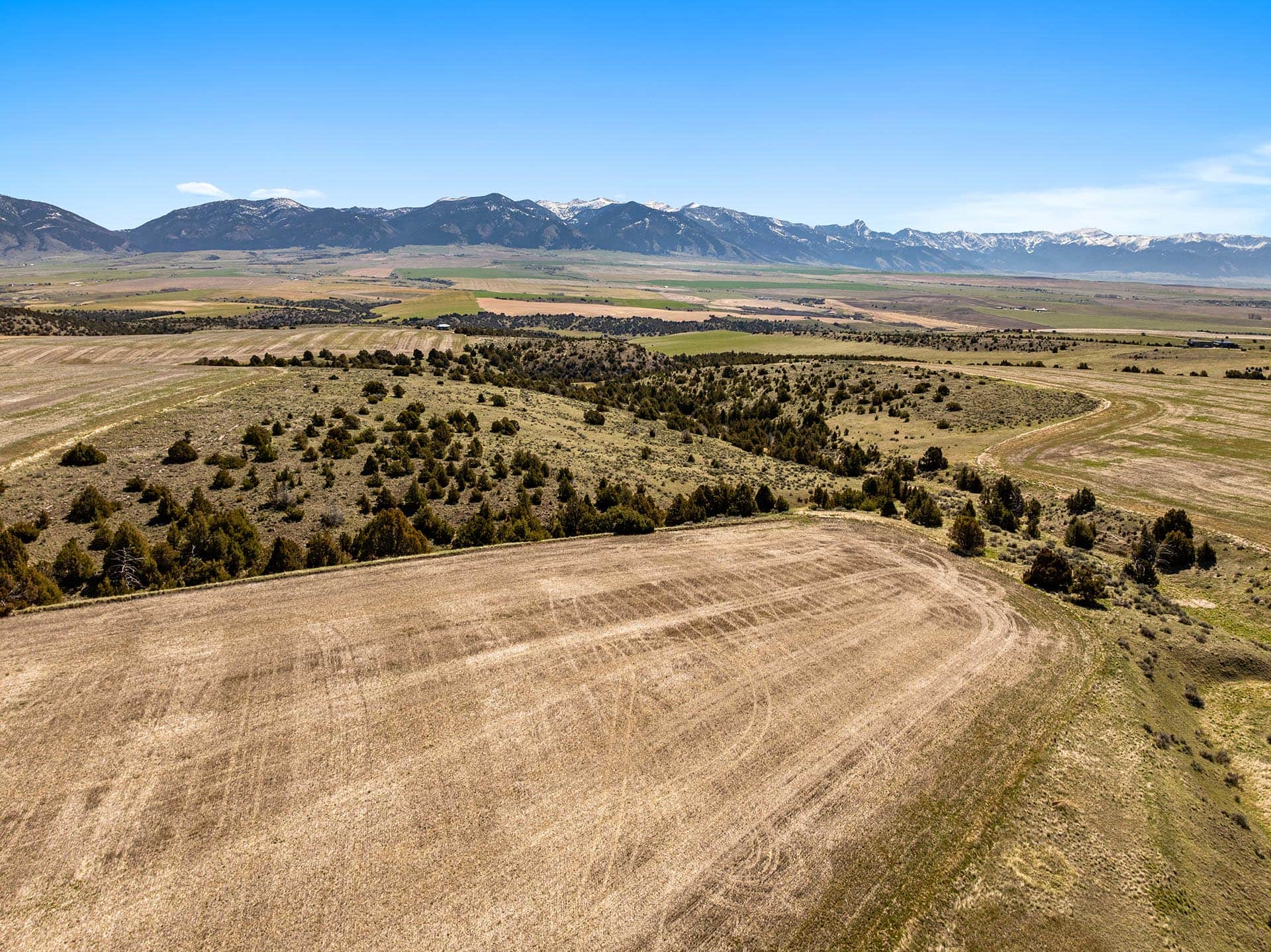 tilled farm land with mountain views montana skinner road sanctuary at sxs ranch
