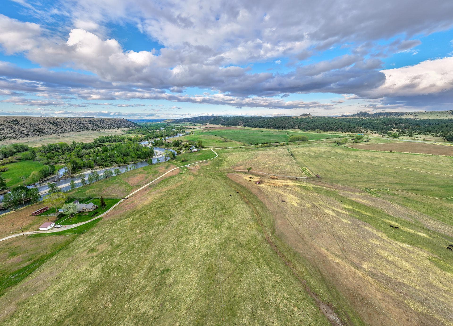 aerial view of winding river and green pastures land montana stillwater riffle ranch