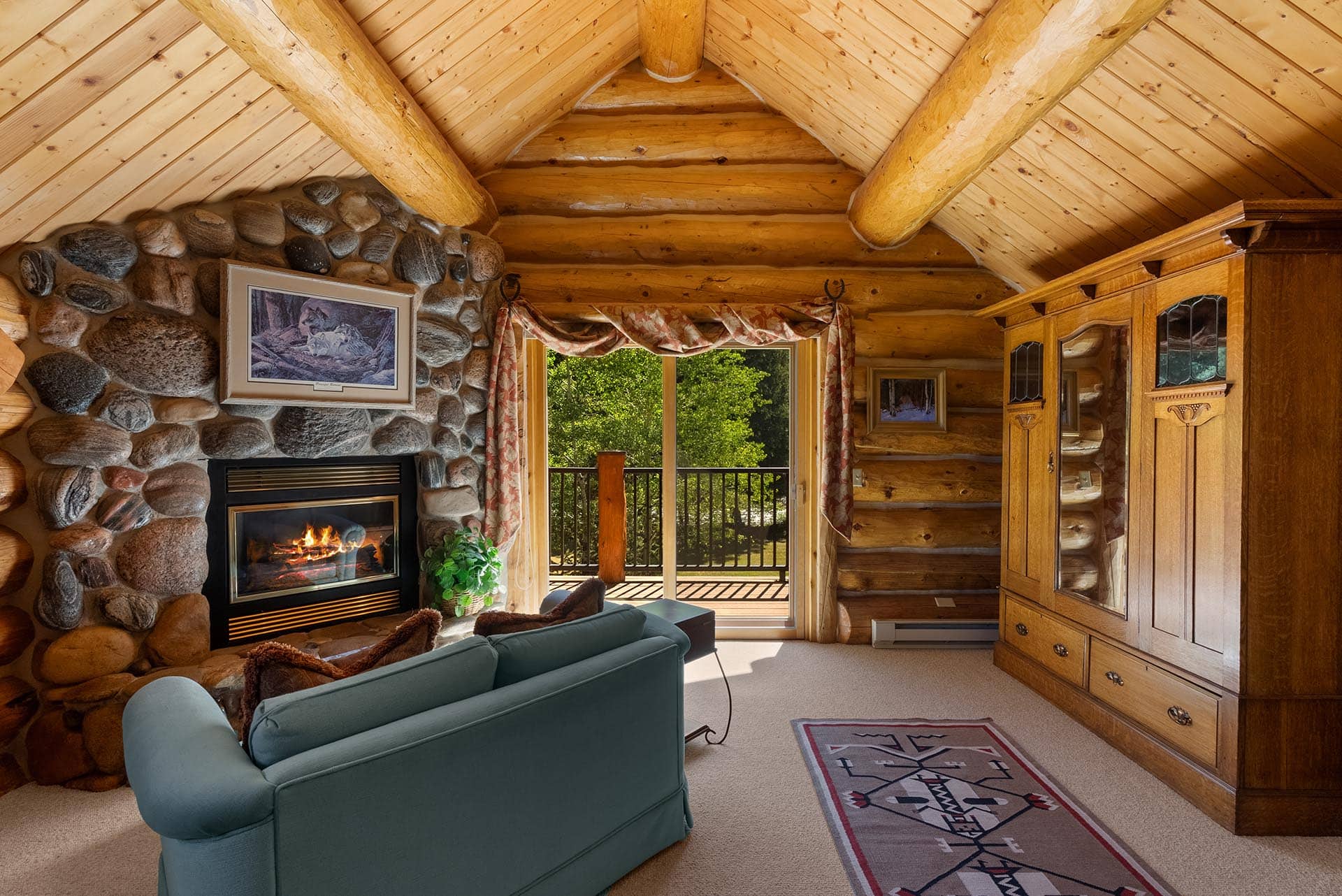 log home bedroom with stone fireplace montana gallatin riverfront retreat in big sky