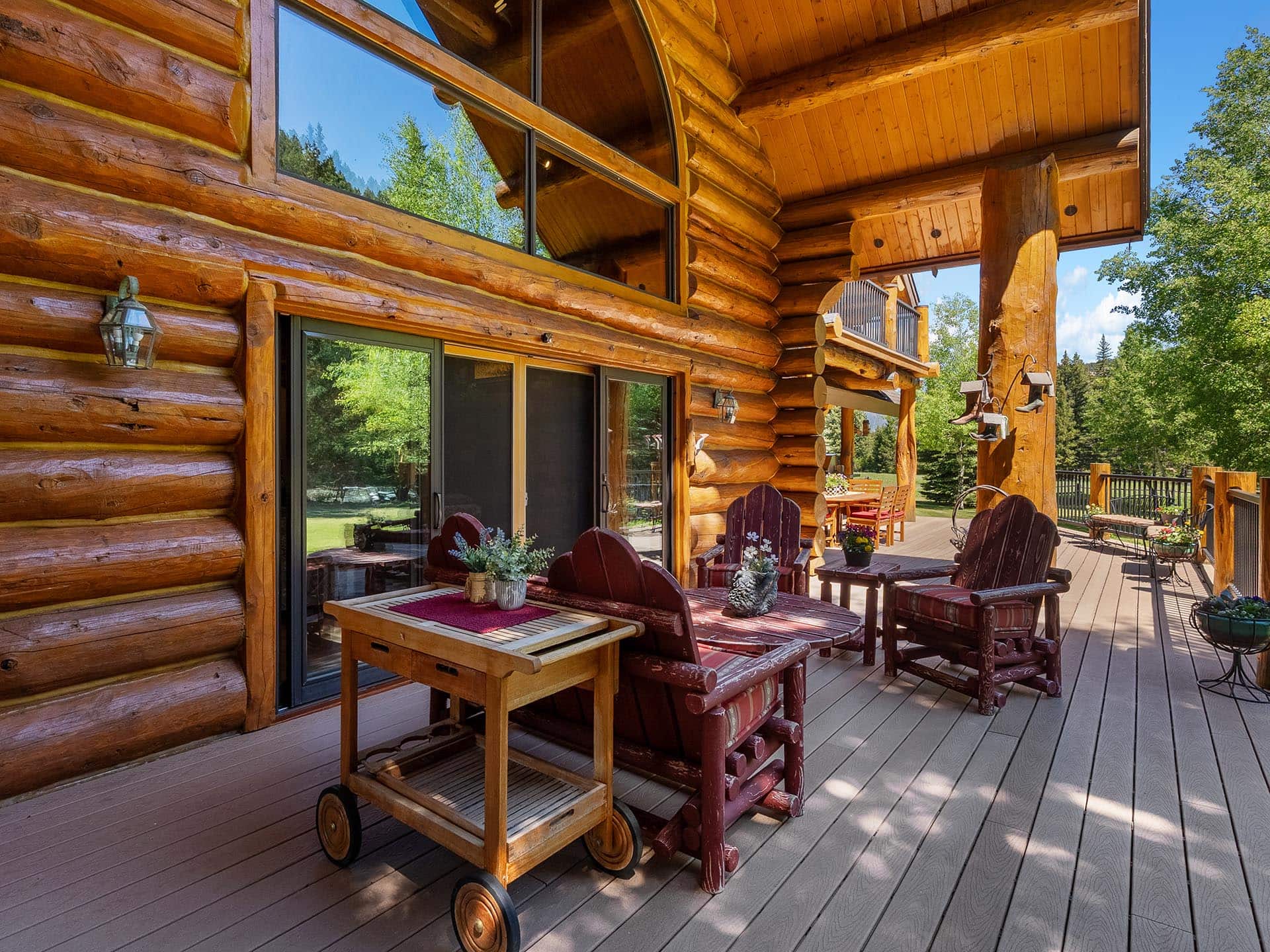 log home deck outdoor seating montana gallatin riverfront retreat in big sky