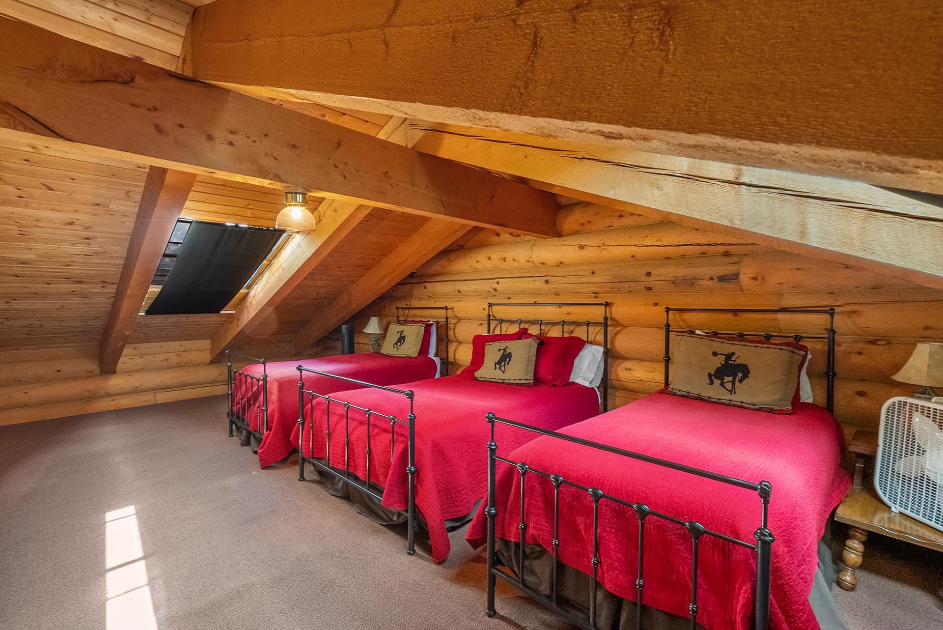 log home loft bedroom with multiple beds montana two rivers lodge