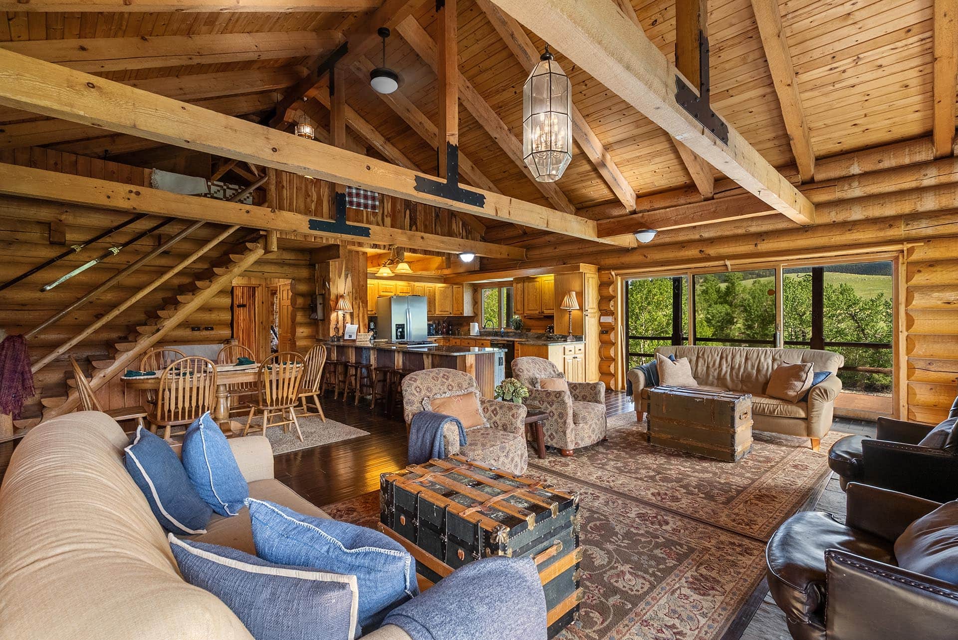 luxury log home interior living room kitchen montana two rivers lodge