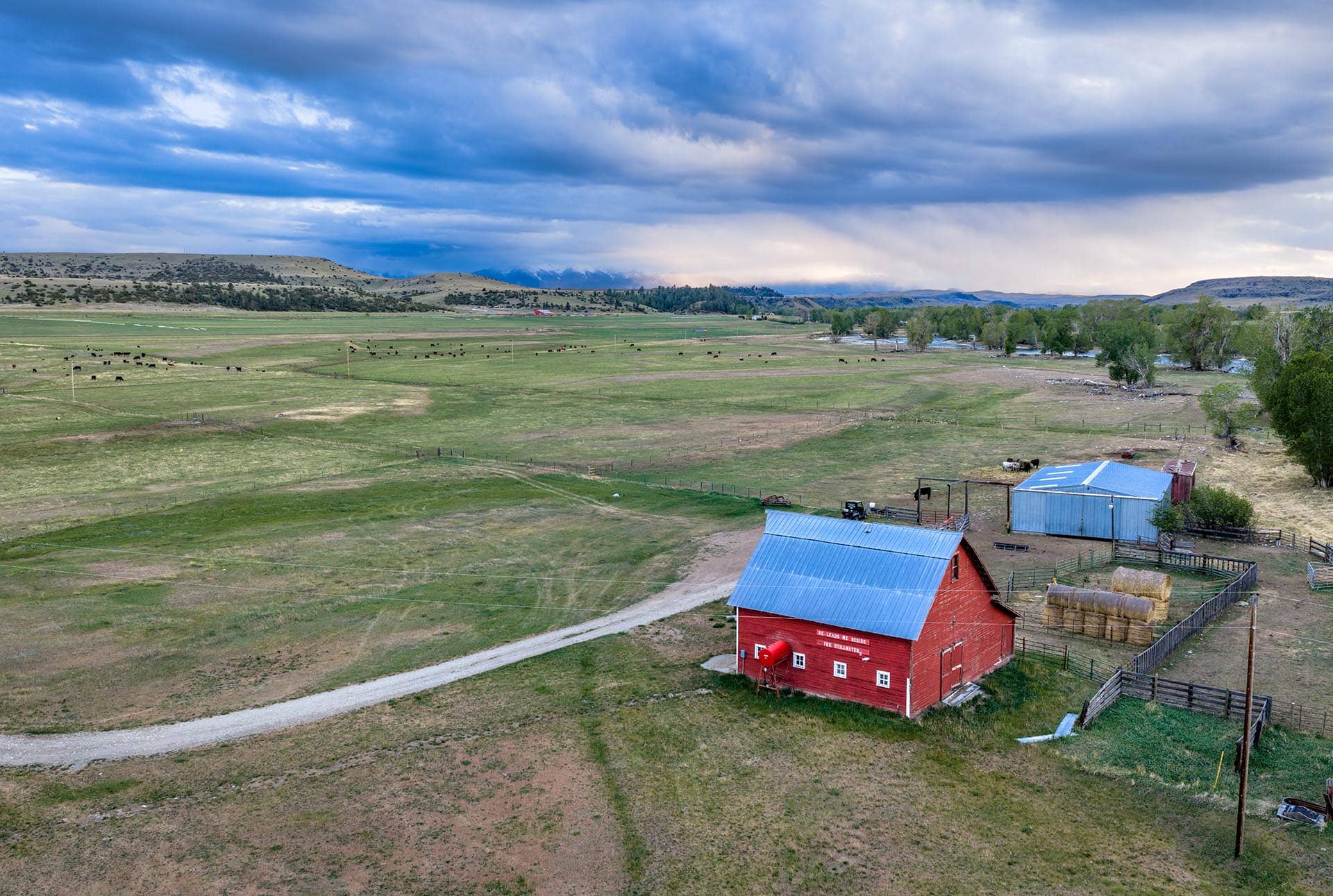 red barn with hay bales and cattle pasture montana stillwater riffle ranch