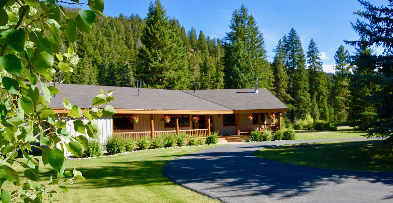 single story home with paved driveway montana gallatin riverfront retreat in big sky