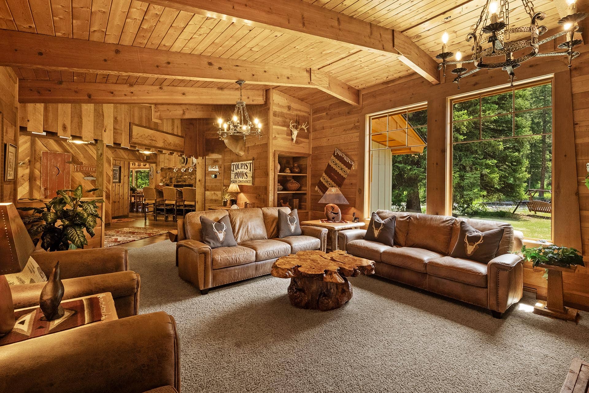 spacious living room with large windows montana gallatin riverfront retreat in big sky