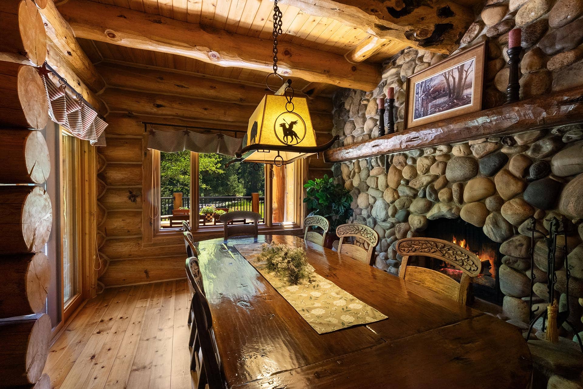 stone fireplace dining area montana gallatin riverfront retreat in big sky