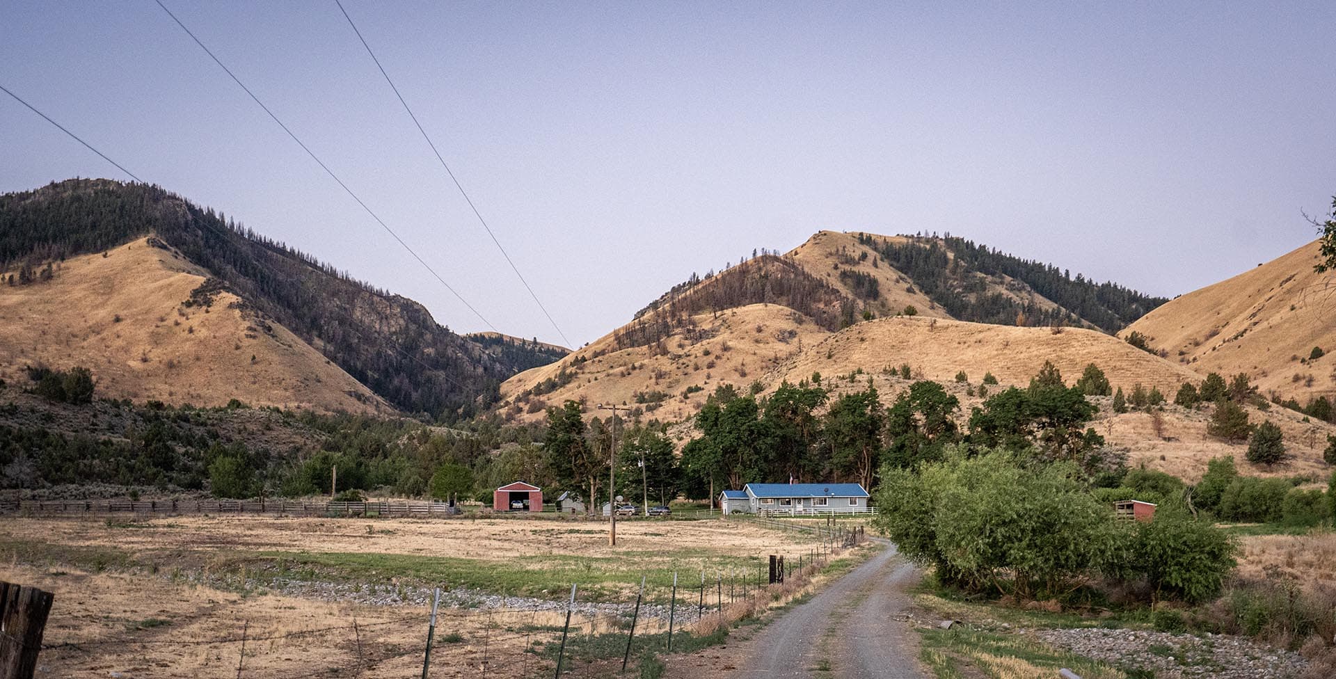 dirt road to ranch buildings and power lines land oregon powell creek ranch