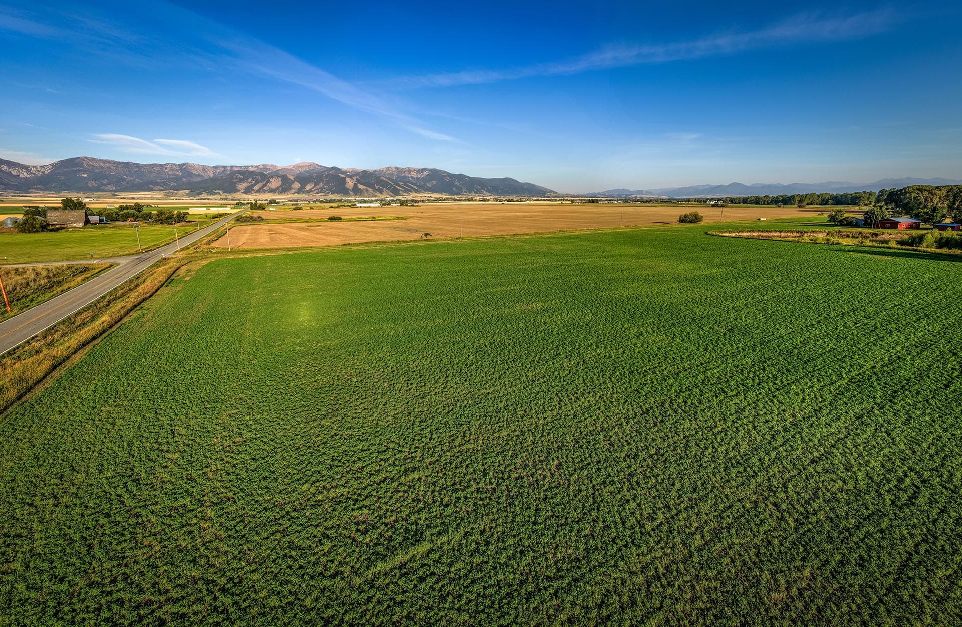 expansive green fields mountain views land montana east gallatin riverlands