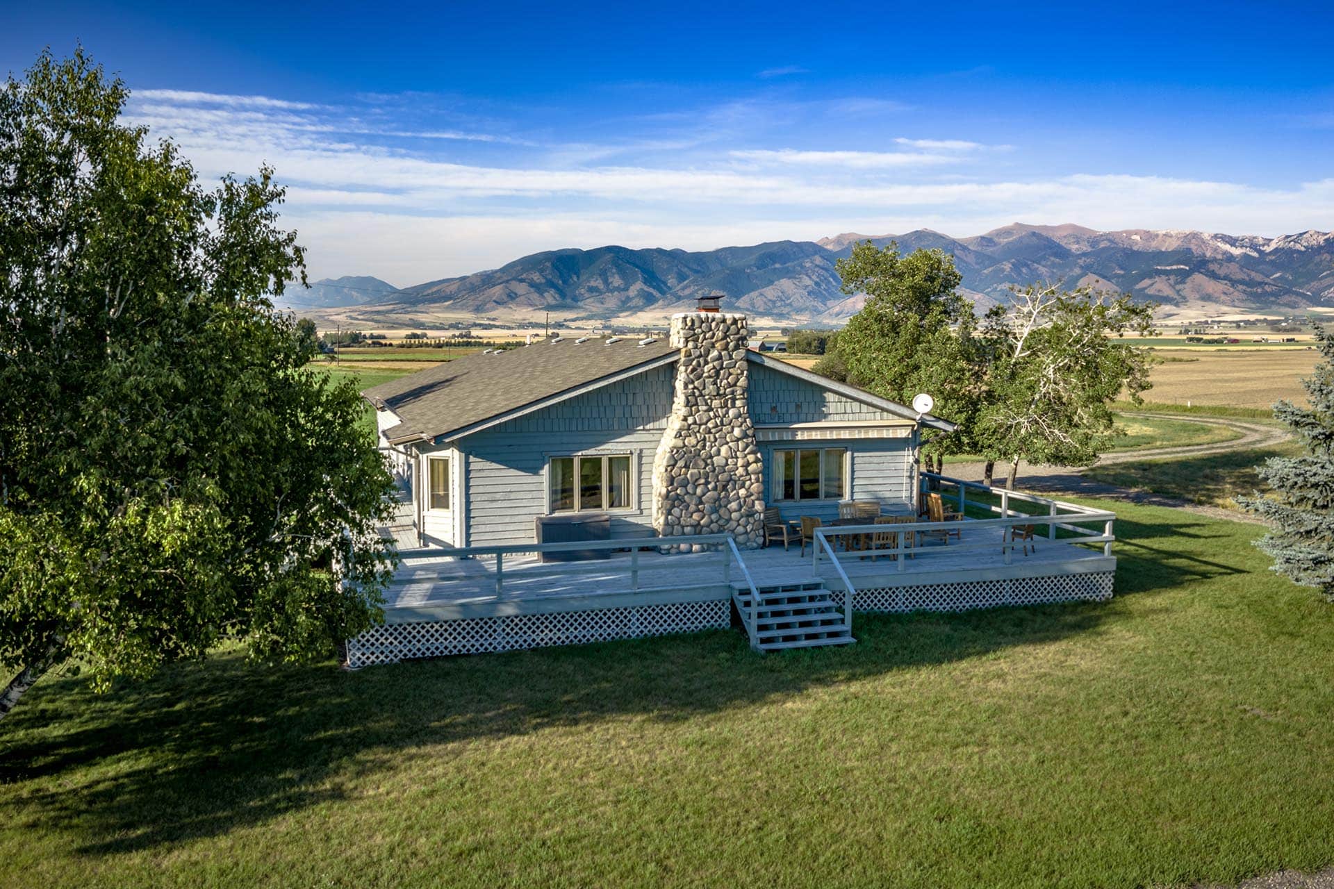 home with stone chimney and deck montana east gallatin riverlands