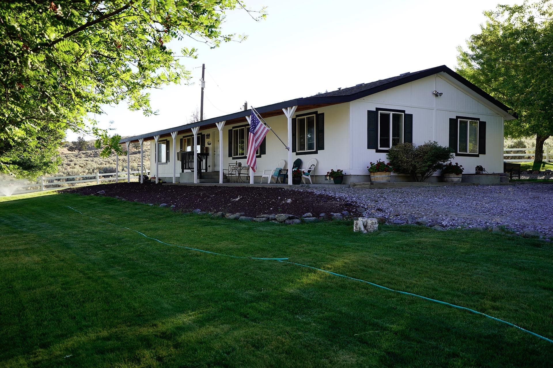ranch house with green lawn and flag hunting sporting property for sale oregon powell creek ranch