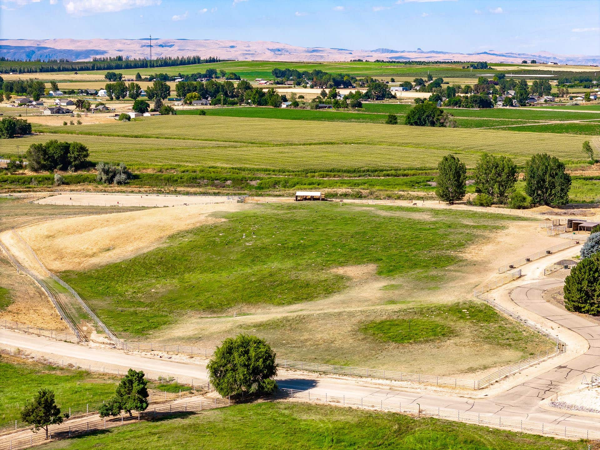 summer aerial view of pasture and road equestrian estate lot idaho