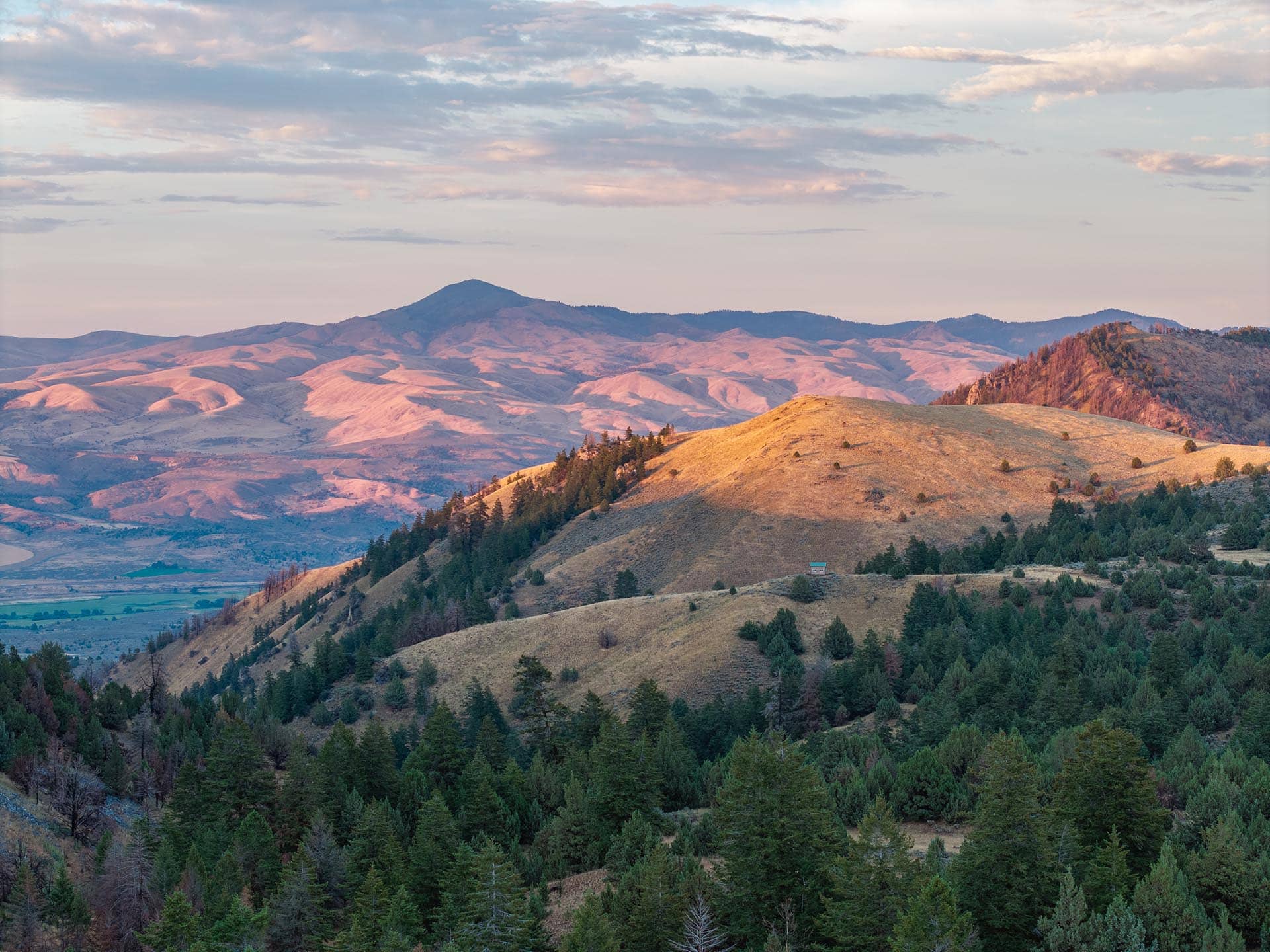 timbered hills with distant cabin land oregon powell creek ranch