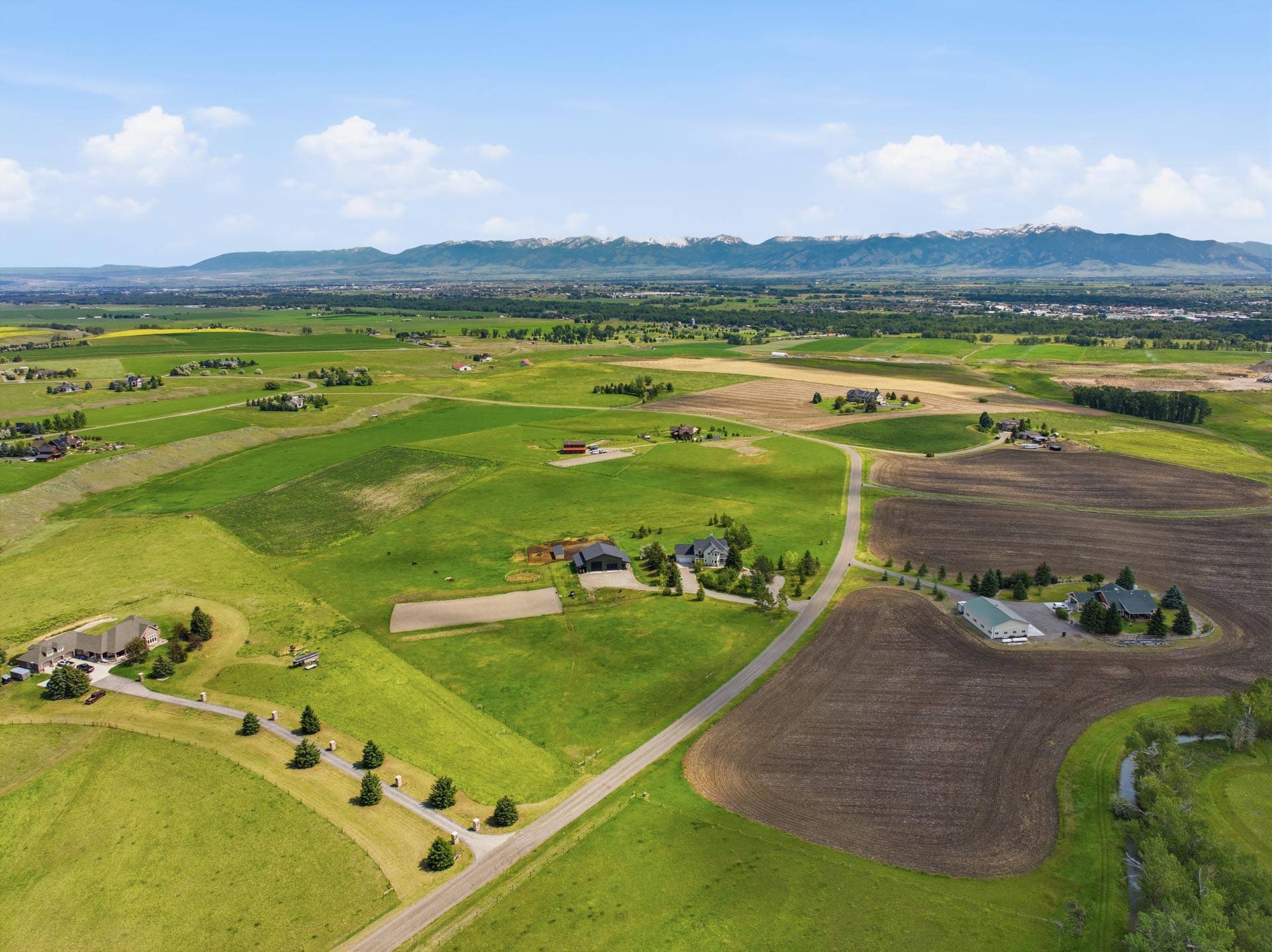 aerial view of green pastures and creek montana trailcrest horse property