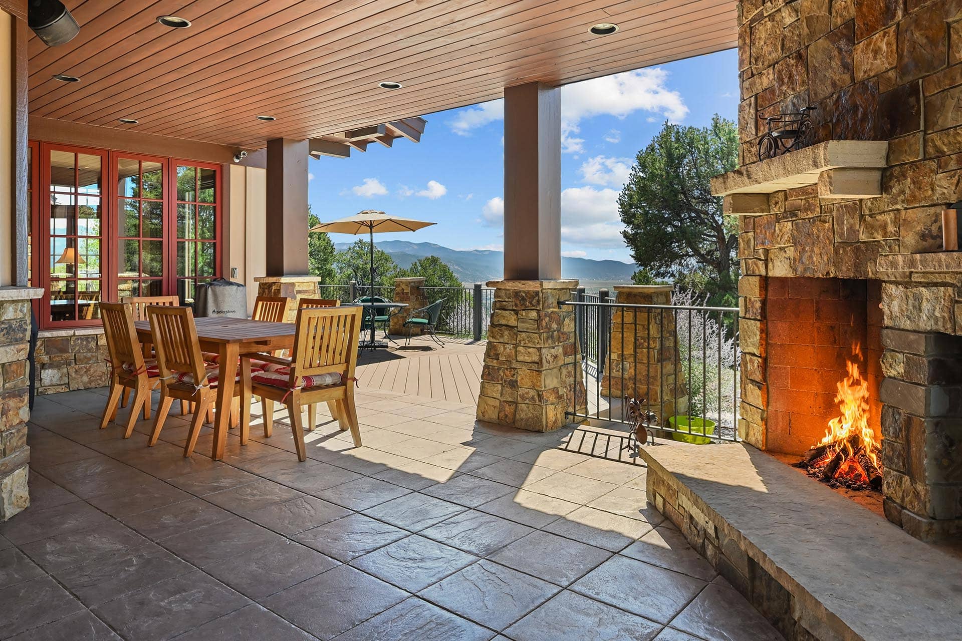 covered patio with outdoor fireplace residential estate colorado collegiate peaks ranch