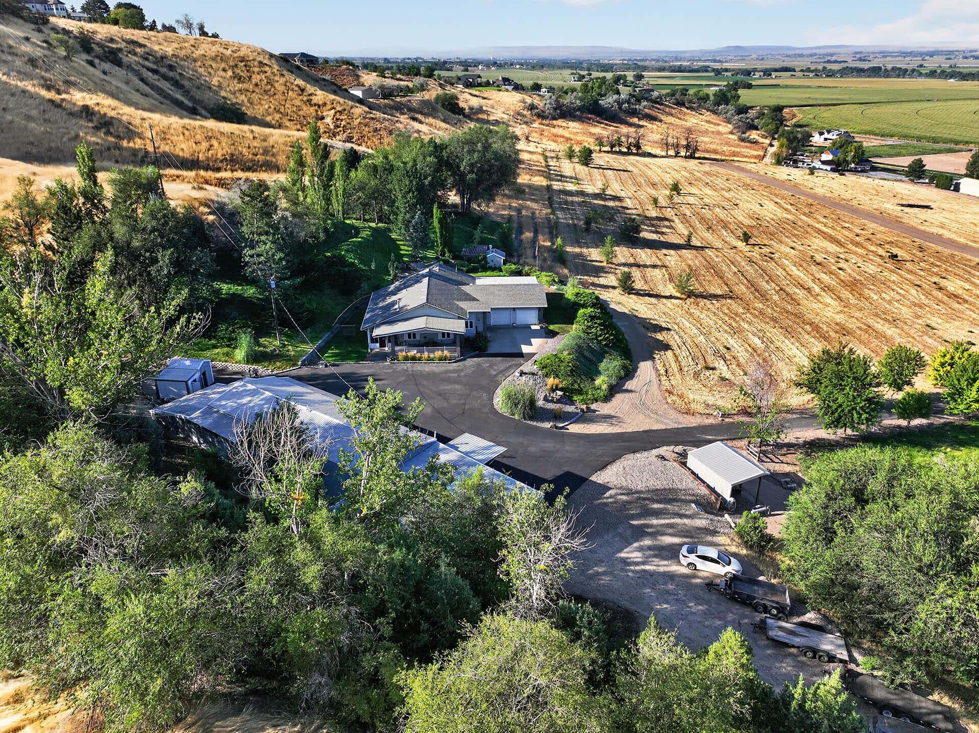 custom home aerial with driveway and fields idaho apple ridge farmstead