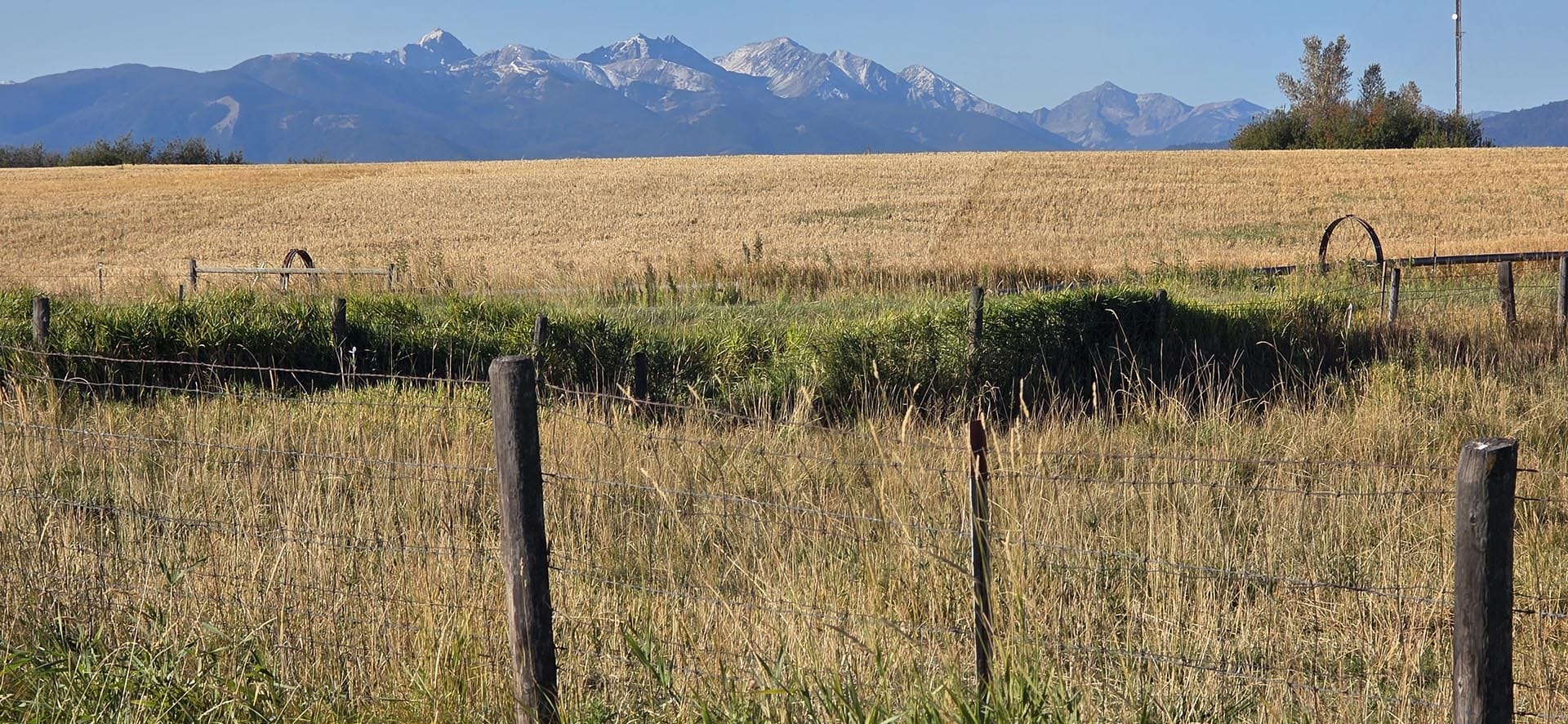 fenced agricultural land with mountain backdrop montana west bozeman homestead