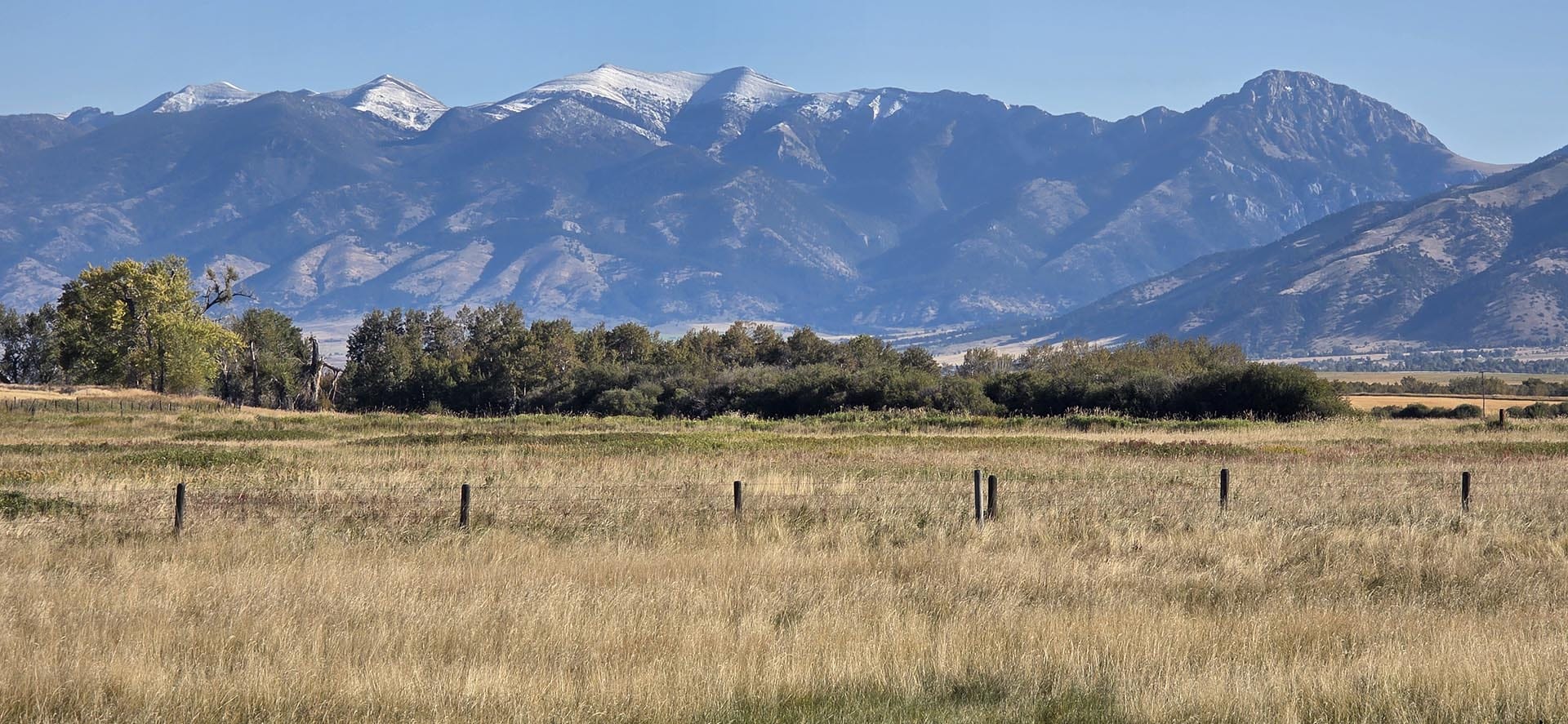 fenced open field with mountain views montana west bozeman homestead