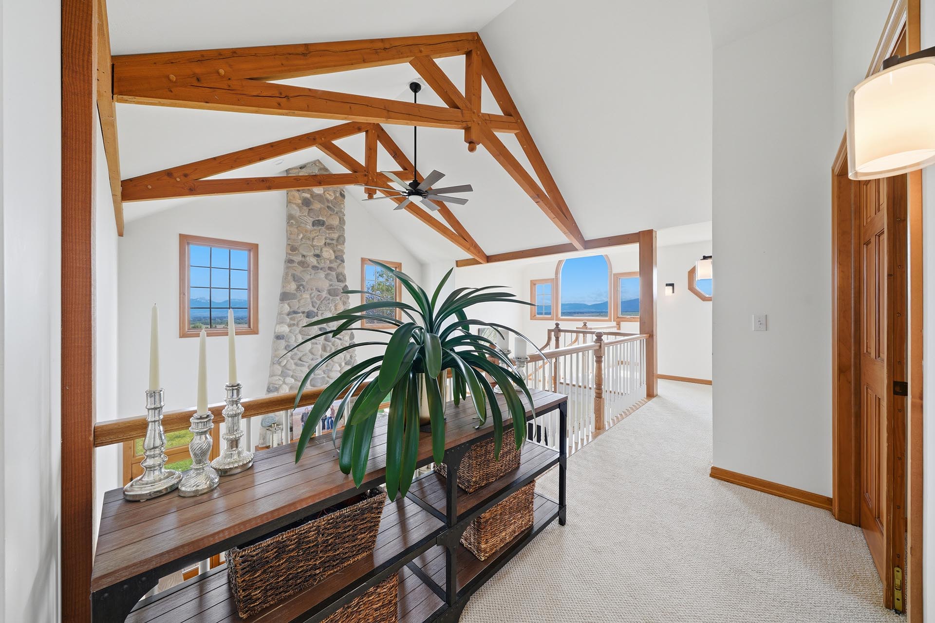 interior living space with exposed beams and mountain views montana trailcrest horse property