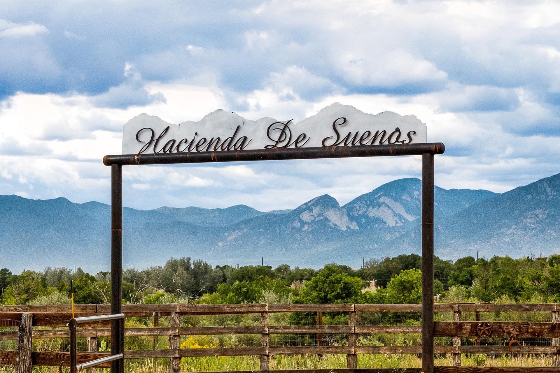land for sale with property entrance and mountain views new mexico hacienda de suenos