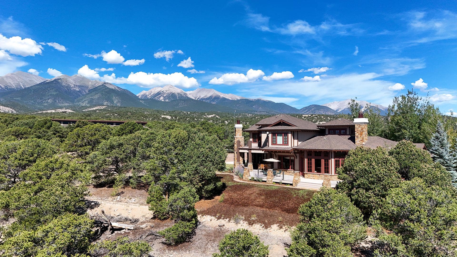 luxury home exterior with snow capped mountain view residential estate for sale colorado collegiate peaks ranch