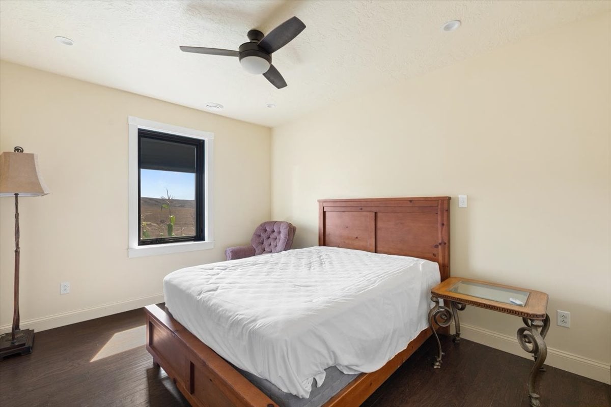 Interior of a bedroom with a bed, window, and ceiling fan at Clarks Fork of the Yellowstone.