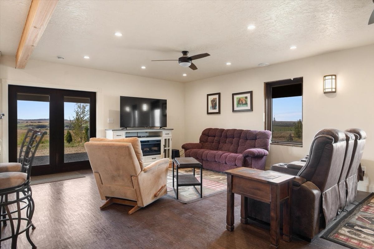Cozy living room with large windows overlooking scenic landscape.