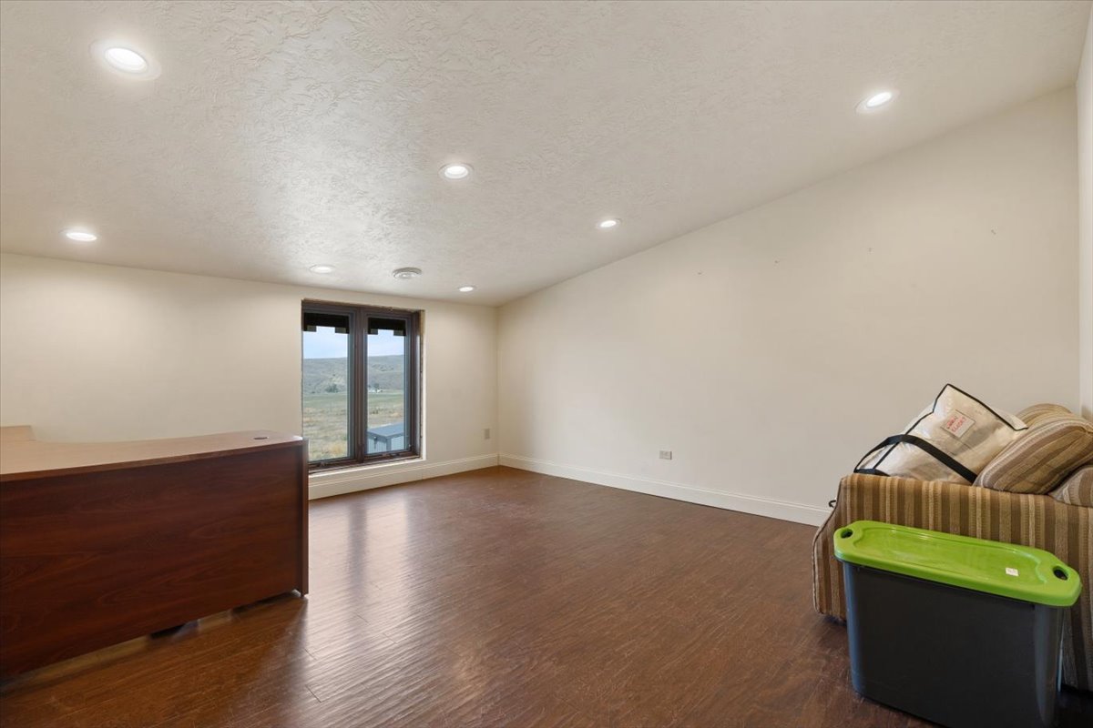 Empty room with large window and hardwood floors at Clarks Fork of the Yellowstone Overlook.