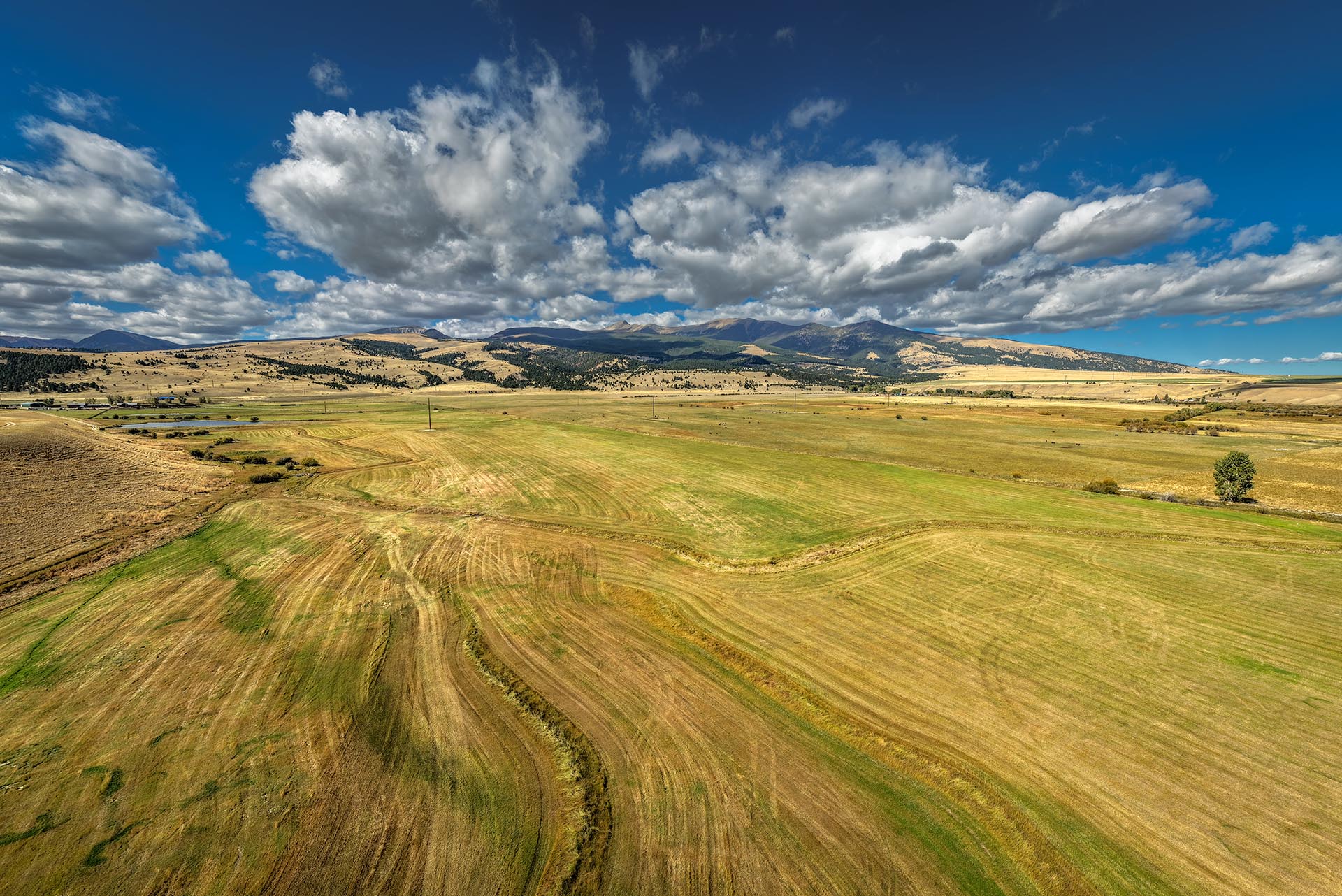 harvested fields mountain views montana dempsey lakes cattle ranch