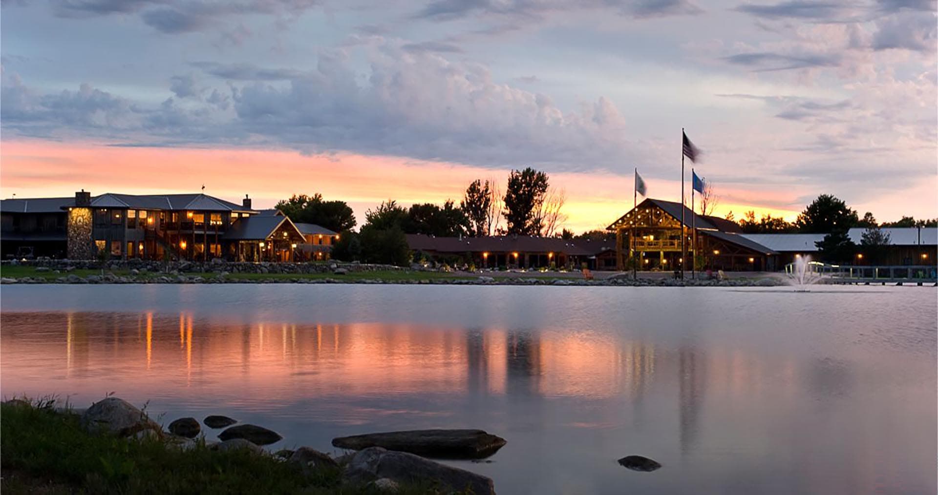 lodge buildings with pond view at sunset south dakota paul nelson farm